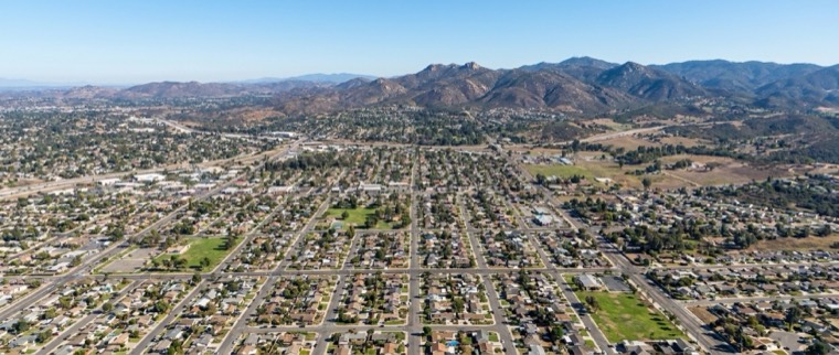 Aerial view of El Cajon neighborhoods beneath the East County mountains