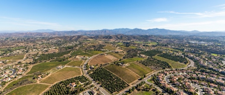 Aerial view of Escondido's rolling hills, groves, and hillside homes